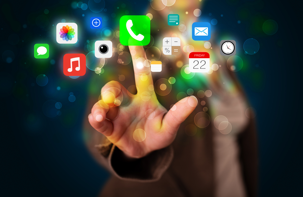 Businesswoman Pressing Colorful Mobile App Icons With Bokeh Background